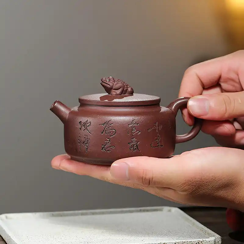 Brown teapot with frog lid.