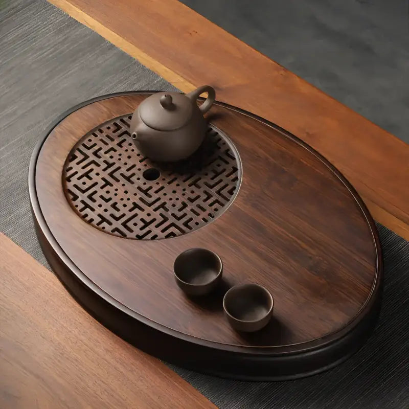 Wooden tea set with teapot and cups on Oval Bamboo Gongfu Tray for bamboo gongfu tea brewing