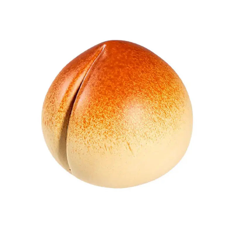Peach-shaped orange cream candy for tea pet guide and feng shui practices in tea rituals
