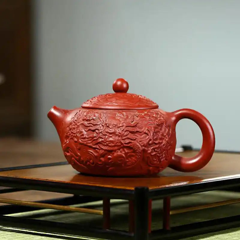 Red, dragon-carved teapot.
