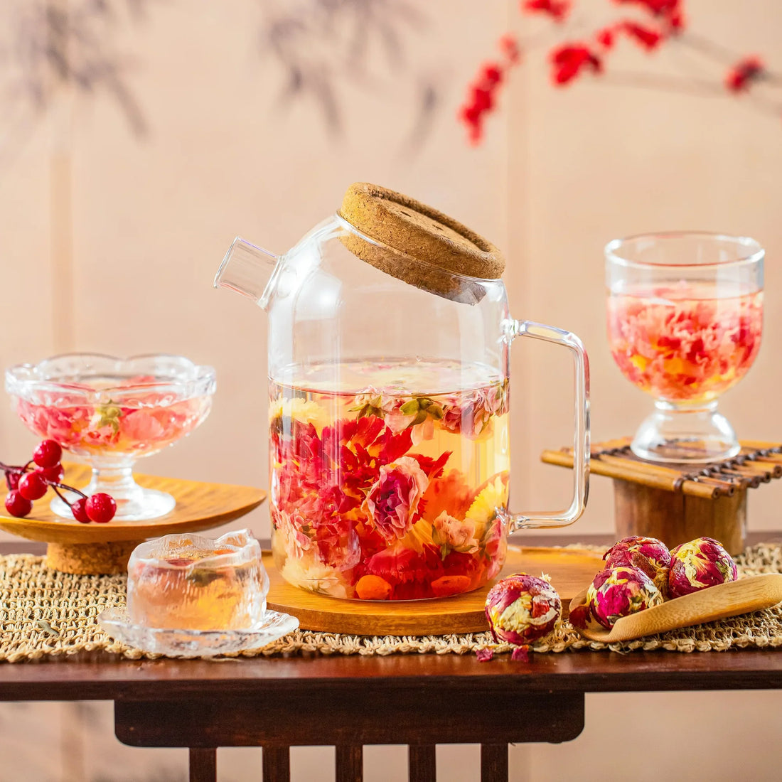 Red flowering tea bloom opening in a clear glass vessel