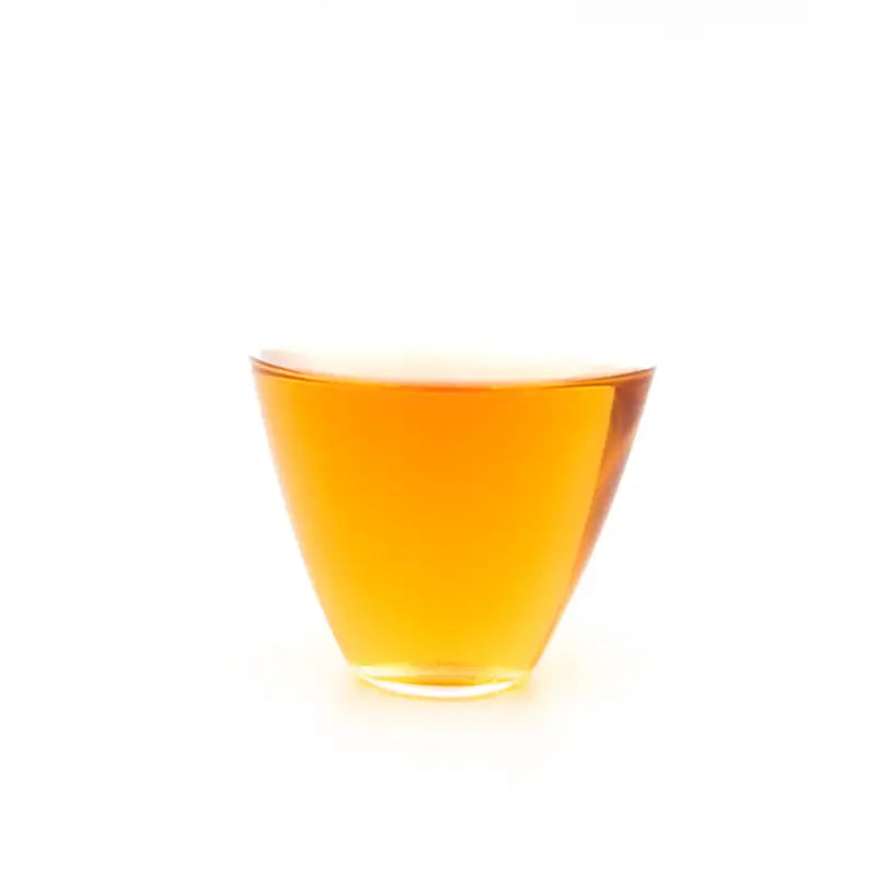 Amber liquid in a clear glass highlighting 2013 Aged Shoumei Brick Tea Fuding White Tea