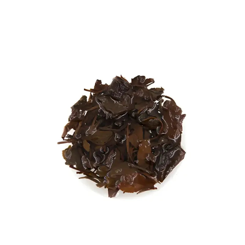 Pile of dark glossy tea leaves from 2013 Aged Shoumei Brick Tea Fuding White Tea