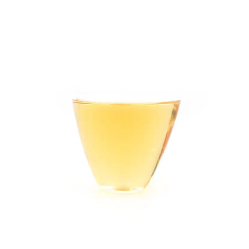 Glass of golden liquid from 2014 Aged Shoumei Dark Aroma Edition white tea
