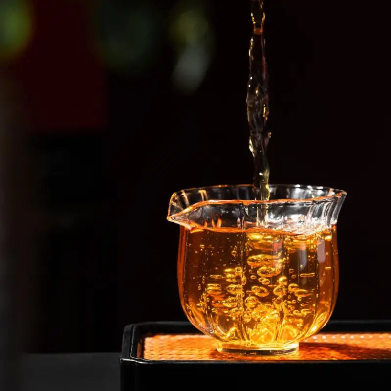 Glass pitcher filling with amber liquid of 2020 Aged Shoumei White Tea Cake for long-term aging