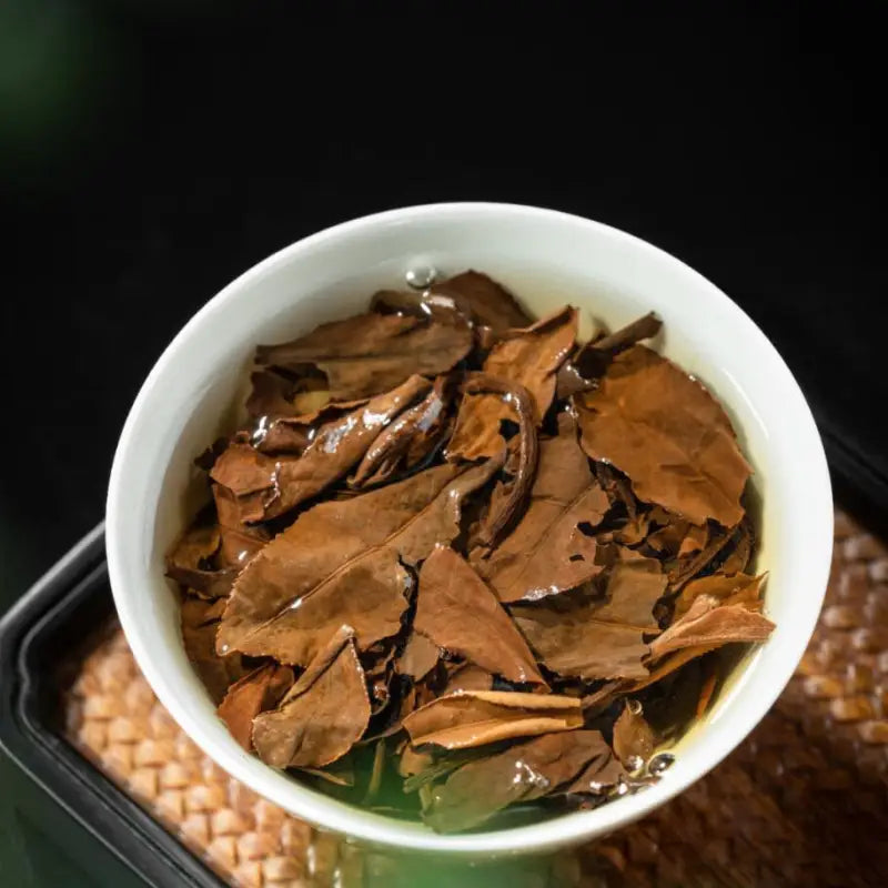 Brewed Fuding Shoumei White Tea Leaves in White Bowl for Aged White Tea Collection