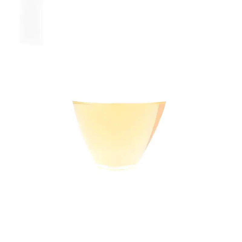 Yellow liquid in a glass showcasing 2020 Aged Shoumei White Tea Cake for long-term aging