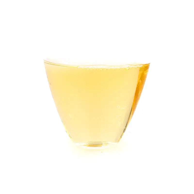 Golden liquid in clear glass of 2020 Bai Mu Dan White Tea showcasing sweet floral notes