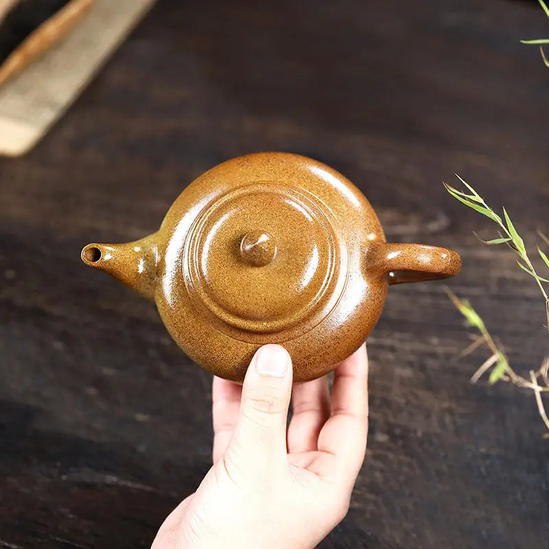 Round brown ceramic teapot from Amber Flow made of Yixing Duanni clay