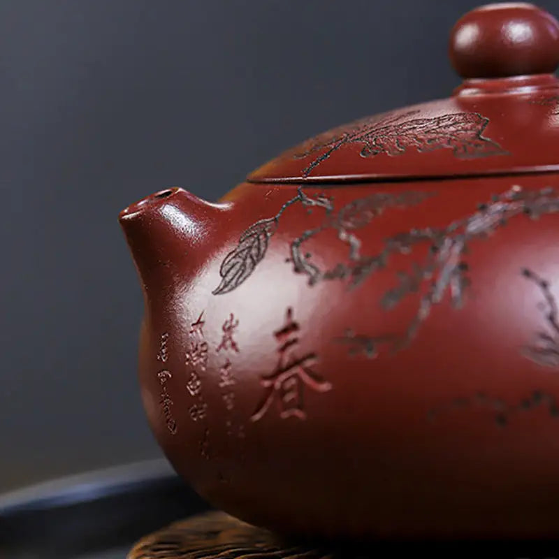Reddish-brown Yixing Zisha teapot with etched floral design from Ancient Plum Tree