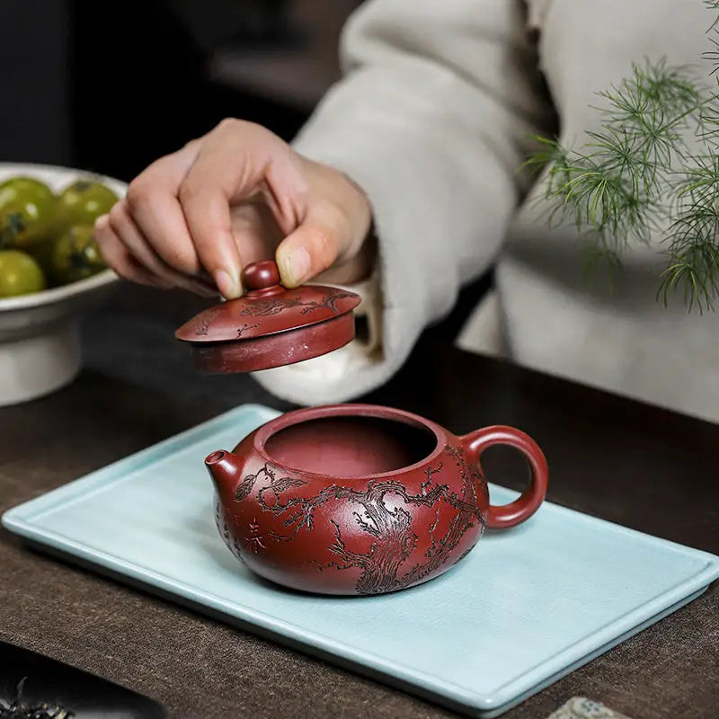 Reddish-brown ceramic teapot with lid from Ancient Plum Tree Yixing Zisha collection