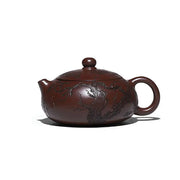 Brown ceramic teapot with etched tree design from Ancient Plum Tree Yixing Zisha collection
