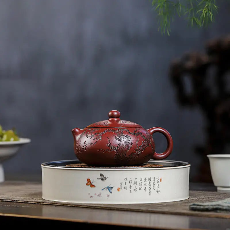Reddish-brown Yixing Zisha teapot with etched design inspired by Ancient Plum Tree