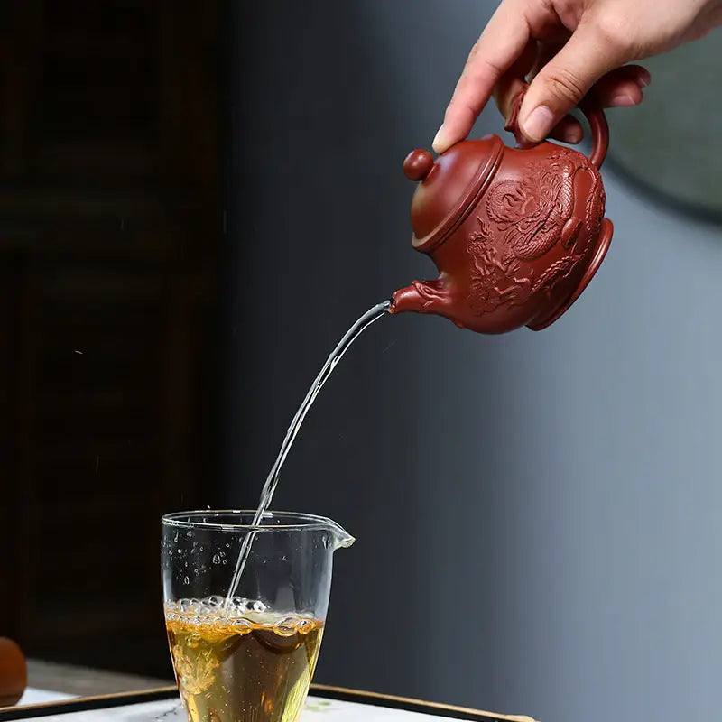 Red clay teapot pouring water from Auspicious Dragon jiashui zitao masterpiece for gongfu tea
