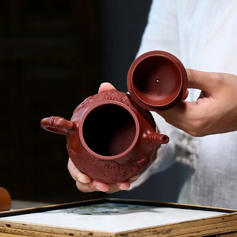 Red Reddish-brown clay teapot with removed lid from Auspicious Dragon, a jiashui zitao masterpiece for gongfu tea brewing