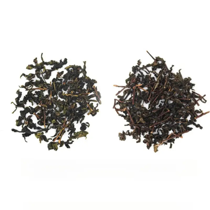 Two piles of dried authentic Anxi Tie Guan Yin oolong tea leaves for red-heart varietals