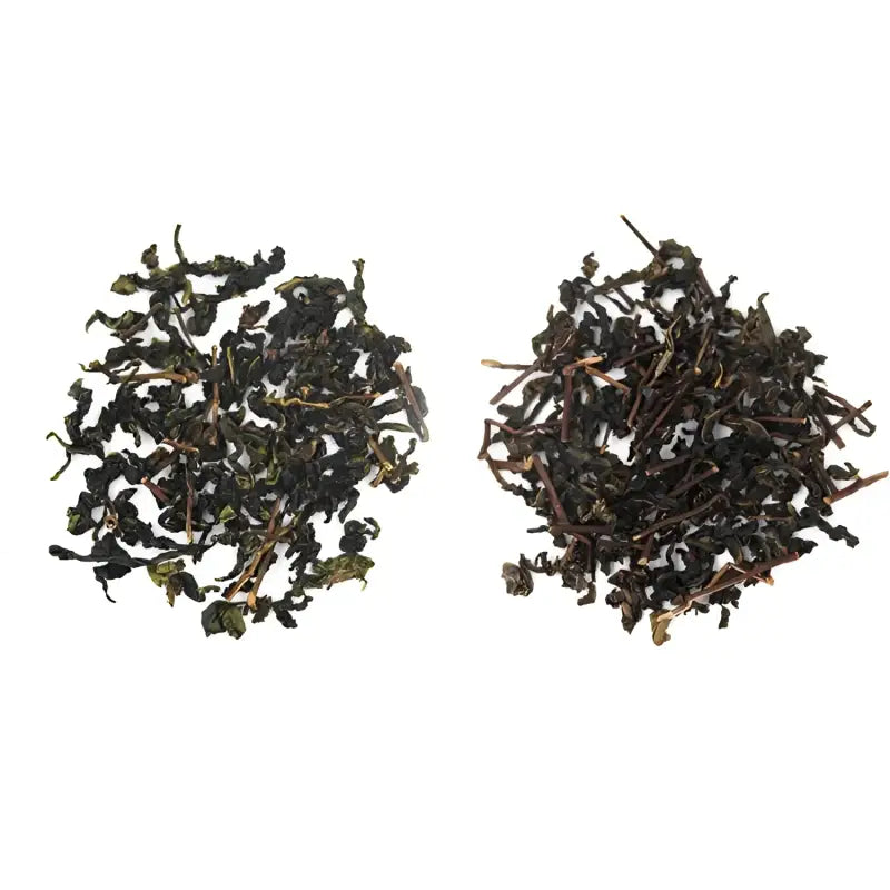 Two piles of dried authentic Anxi Tie Guan Yin oolong tea leaves for red-heart varietals