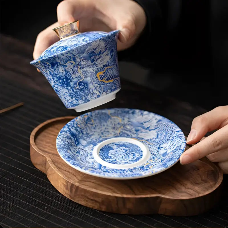 Blue and white dragon-patterned tea set showcasing Azure Dragon Gaiwan for Jingdezhen enamel art and gongfu tea brewing