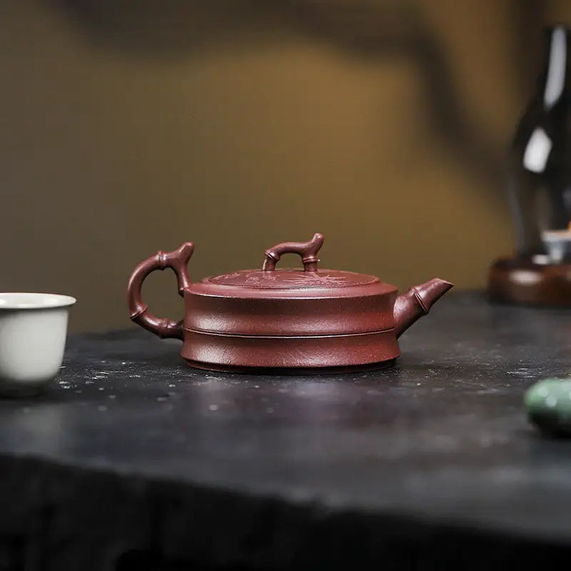 Maroon ceramic teapot with yixing zisha and hand-carved bamboo pattern in Bamboo Grove