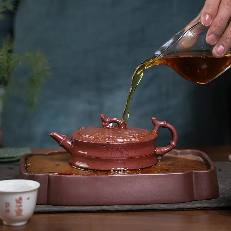 Reddish-brown Yixing Zisha bamboo grove teapot with hand-carved bamboo pattern and ornate handle