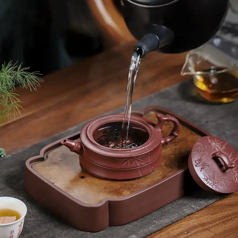 Earthenware yixing zisha teapot with hand-carved bamboo pattern from Bamboo Grove display