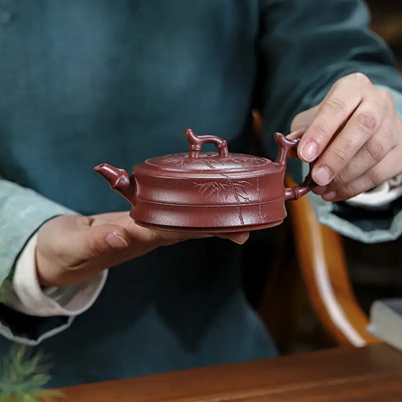 Maroon ceramic Yixing Zisha teapot with hand-carved bamboo pattern from Bamboo Grove collection