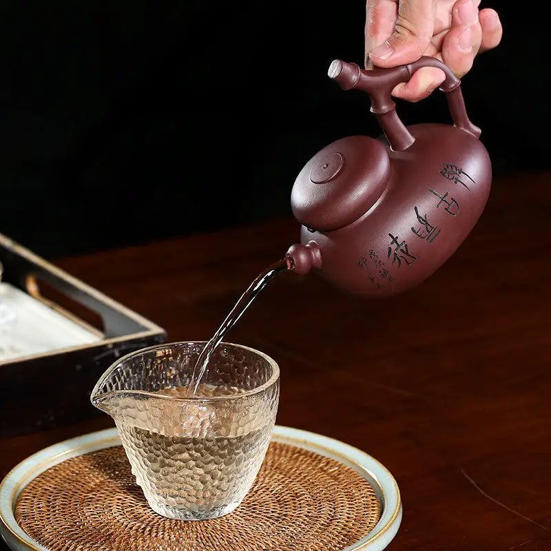 Purple Yixing Zisha Teapot pouring into textured glass in Bamboo Path Gongfu Tea Set