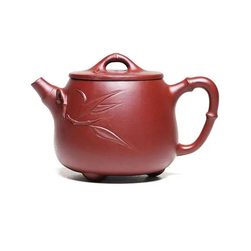 Maroon ceramic teapot with carved bamboo design from Bamboo Zen showcasing harmony and Yixing Zisha craftsmanship