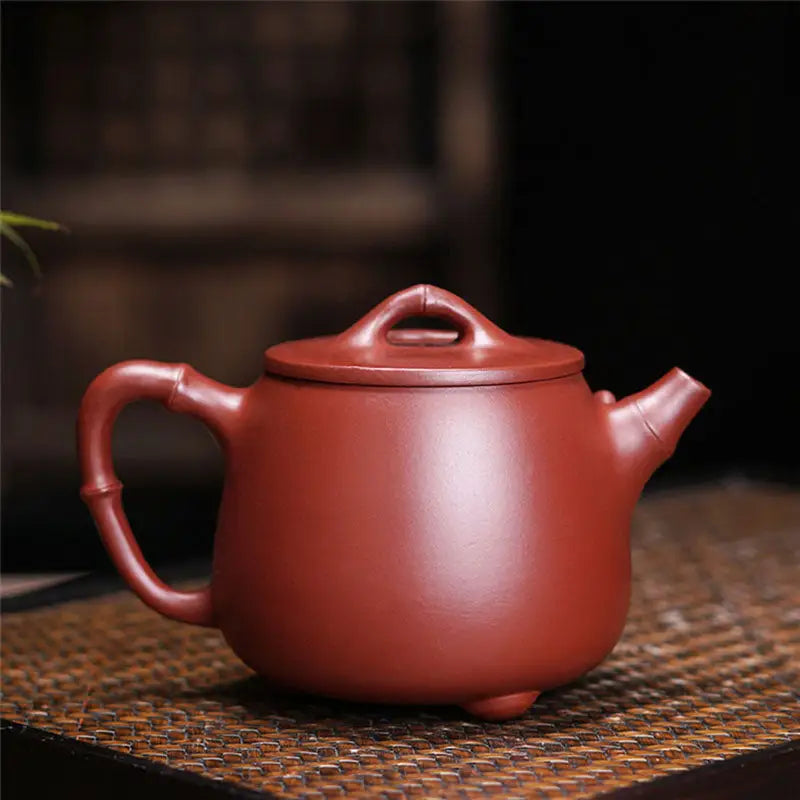 Reddish-brown ceramic teapot inspired by Bamboo Zen harmony with carved bamboo details