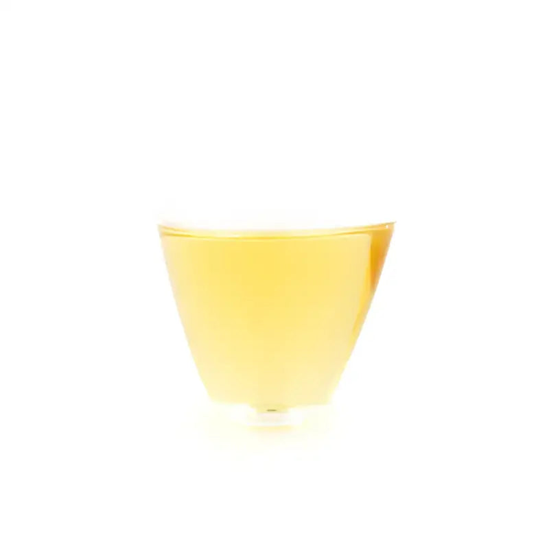 Glass of yellow liquid from Bingdao Lao Zhai Raw Pu-erh 2024 tea product