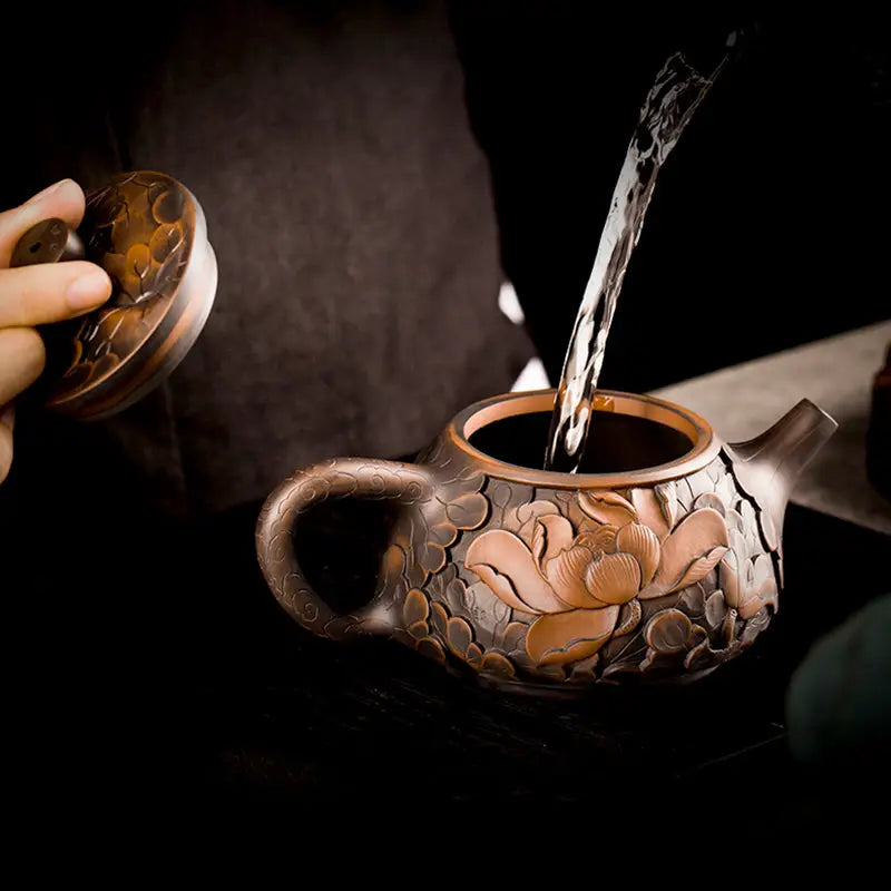Ornate Brown Jianshui Zitao Teapot from Bloom II being filled, showcasing purple clay modern tea design