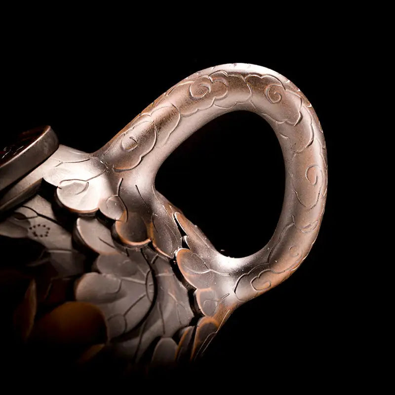 Ornate metal handle on Bloom II jianshui zitao teapot with purple clay modern tea design