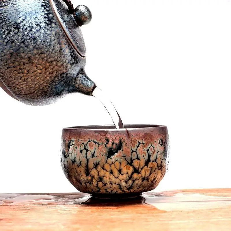 Ceramic Bloom Teapot pouring into matching cup with blooming glaze pattern for gongfu tea