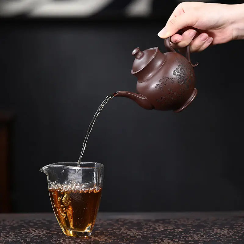 Brown teapot pouring tea from Blooming Scroll Yixing Zisha Zini Clay teapot