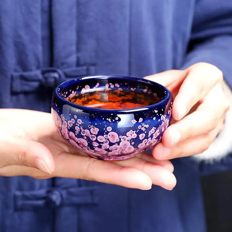 Blue and pink speckled tea cup from Blossom Jian Zhan with spring petals design for tea masters