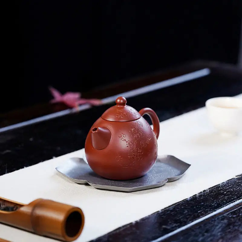 Round reddish-brown Yixing Zisha Blossom Verse teapot with floral design