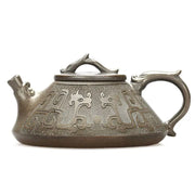 Ornate bronze dragon teapot featuring tribal dragon motif and yixing zisha style craftsmanship