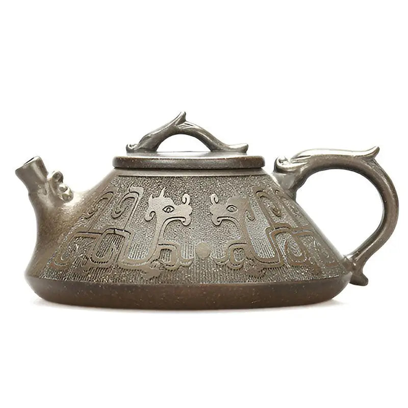 Ornate bronze dragon teapot featuring tribal dragon motif and yixing zisha style craftsmanship