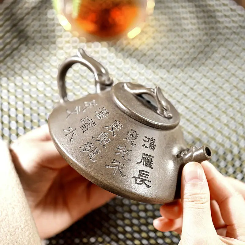 Engraved brown Yixing Zisha teapot with tribal dragon motif from Bronze Dragon collection