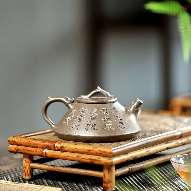Engraved brown Yixing Zisha teapot with tribal dragon motif in Bronze Dragon style