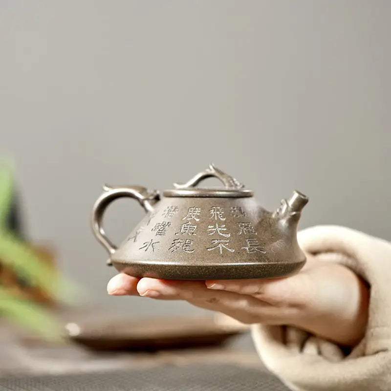 Engraved brown Yixing Zisha teapot with tribal dragon motif in Bronze Dragon style