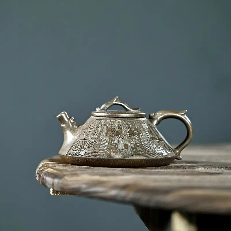 Ornate silver teapot with tribal dragon motif in Bronze Dragon collection, high-quality yixing zisha craftsmanship