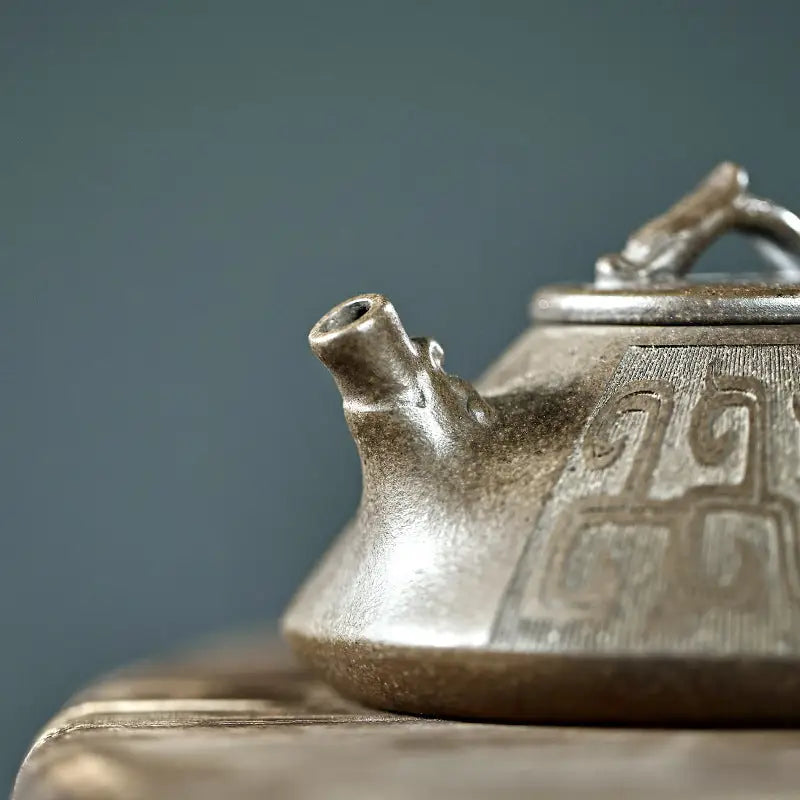 Ornate bronze dragon teapot with tribal dragon motif, perfect for yixing zisha collections