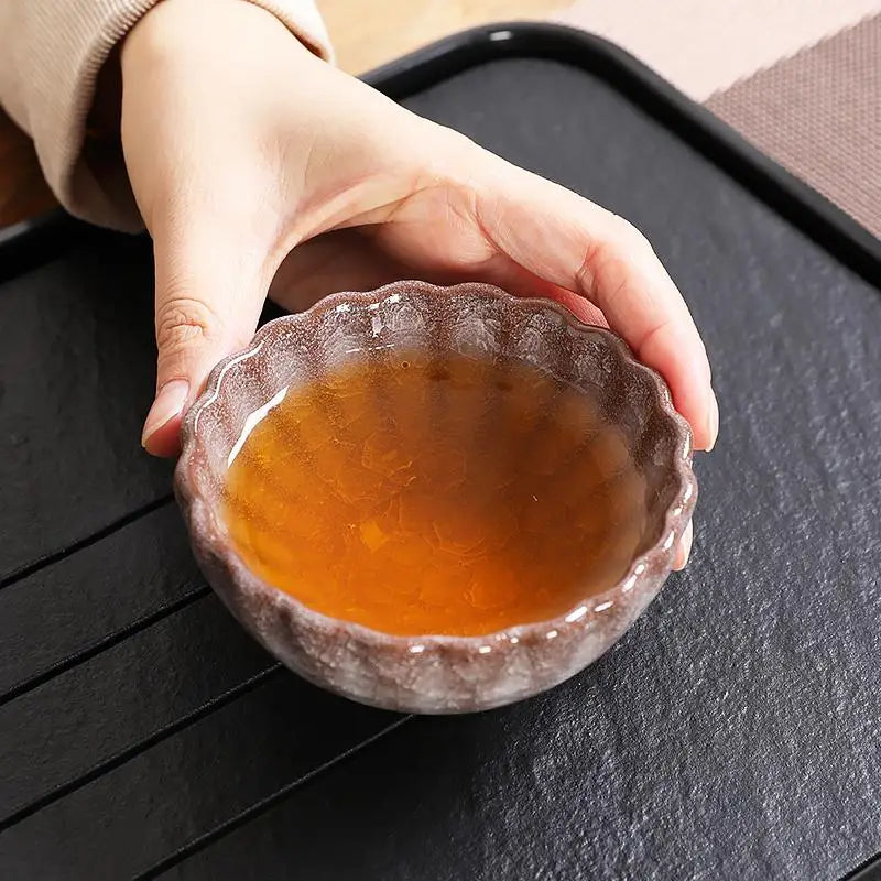 Small bowl of amber liquid from Brownie featuring jian zhan crackled minerals and glossy crystal glaze