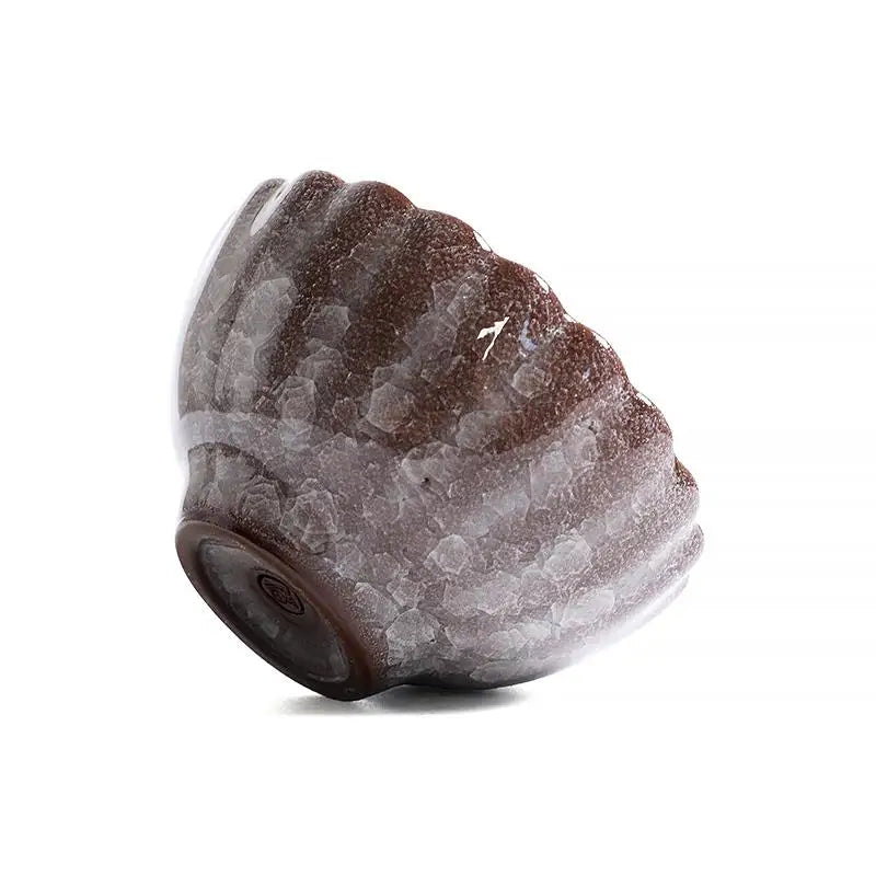 Textured brown and white ceramic bowl from Jian Zhan with crackled minerals and glossy crystal glaze
