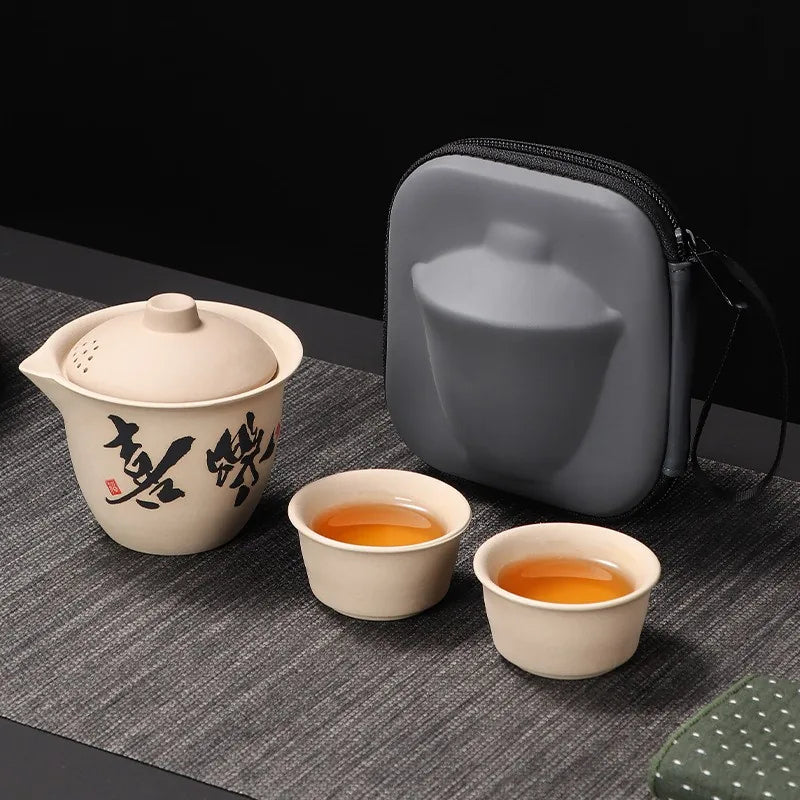 Coarse stoneware travel tea set with calligraphy teapot, two cups and grey case – photo 1