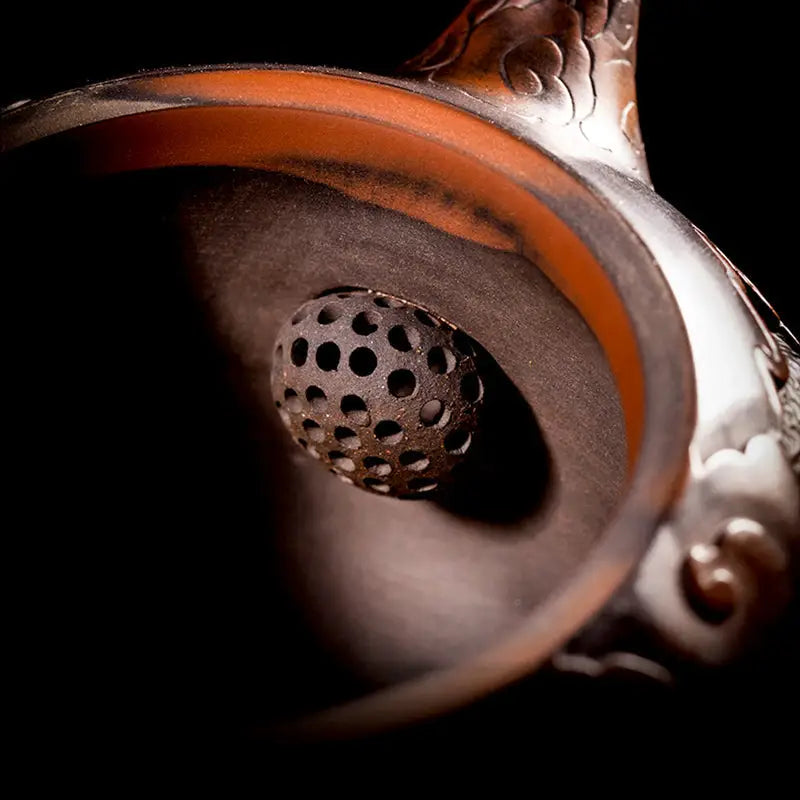 Ornate metal incense burner from Carving Dragon with a hand-carved dragon design