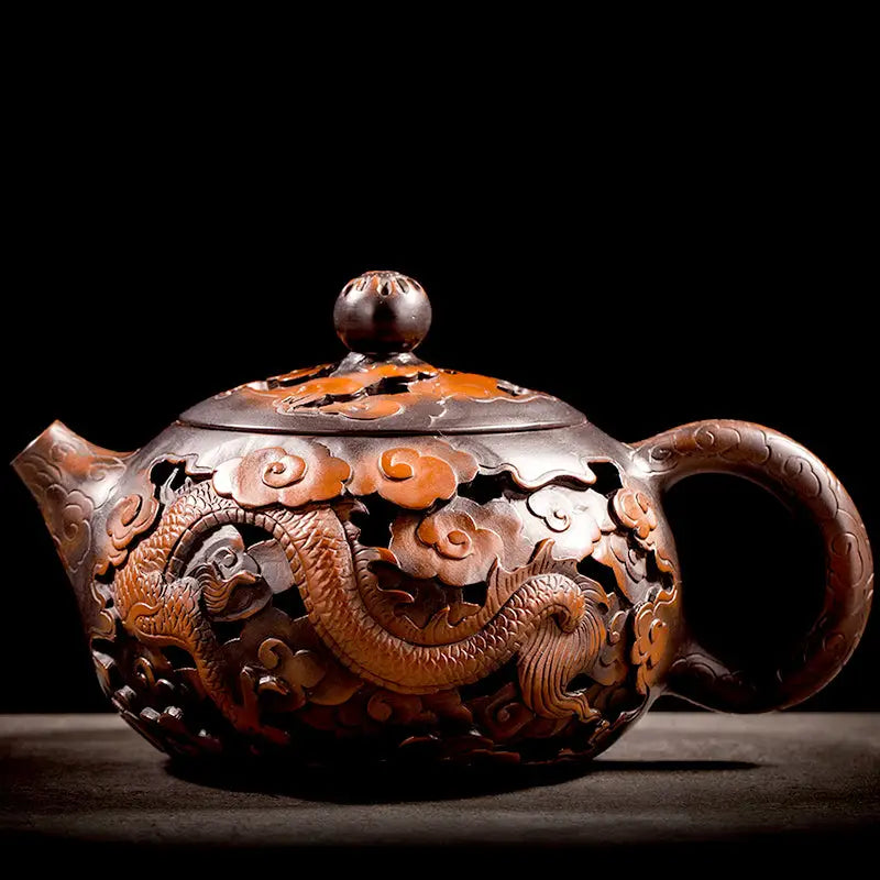 Ornate brown jianshui zitao teapot with hand-carved dragon and cloud carvings