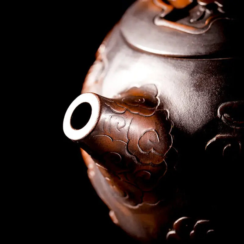 Ornate brown teapot spout featuring a hand-carved dragon from the Carving Dragon jianshui zitao teapot collection