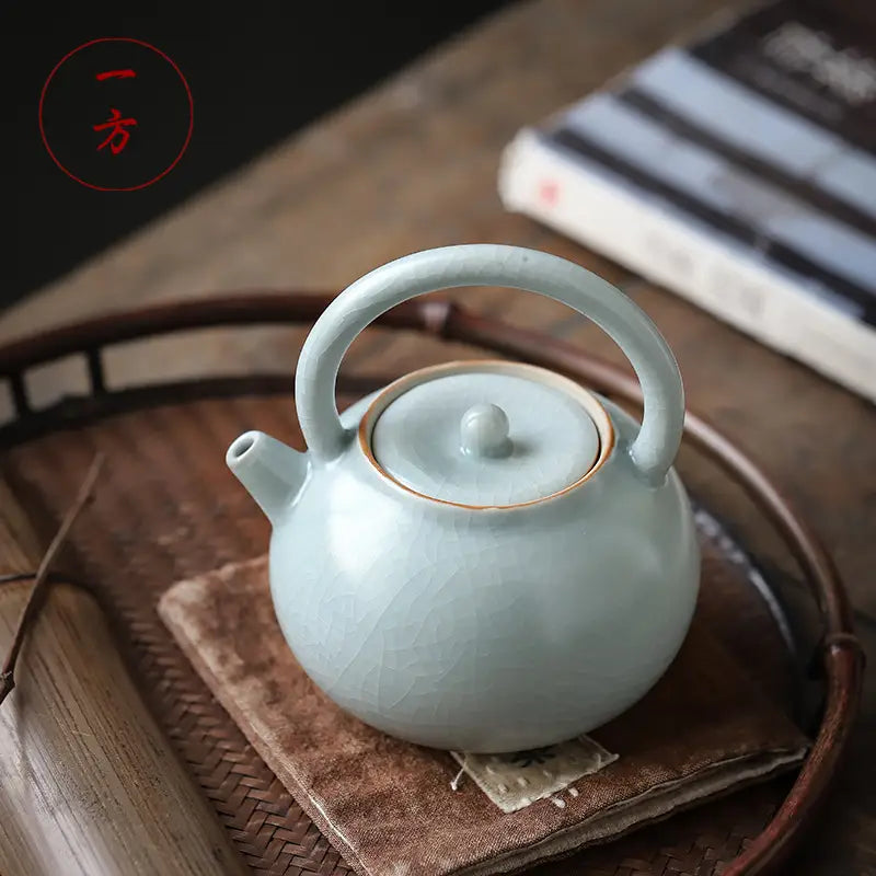Light blue ceramic teapot with crackle glaze in the Celadon Ru Kiln style